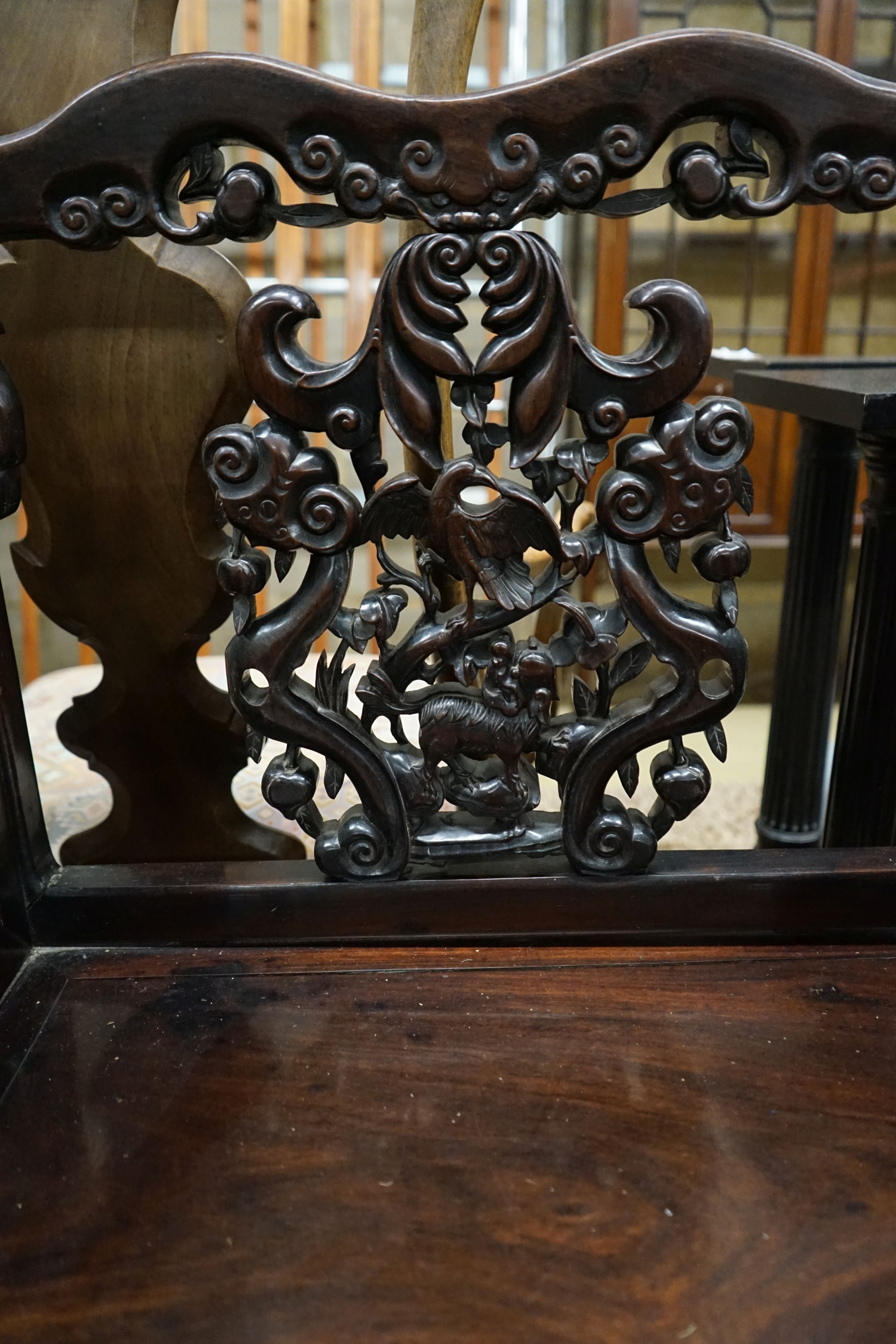 A pair of Chinese carved hongmu elbow chairs (a.f.), width 65cm, depth 48cm, height 96cm